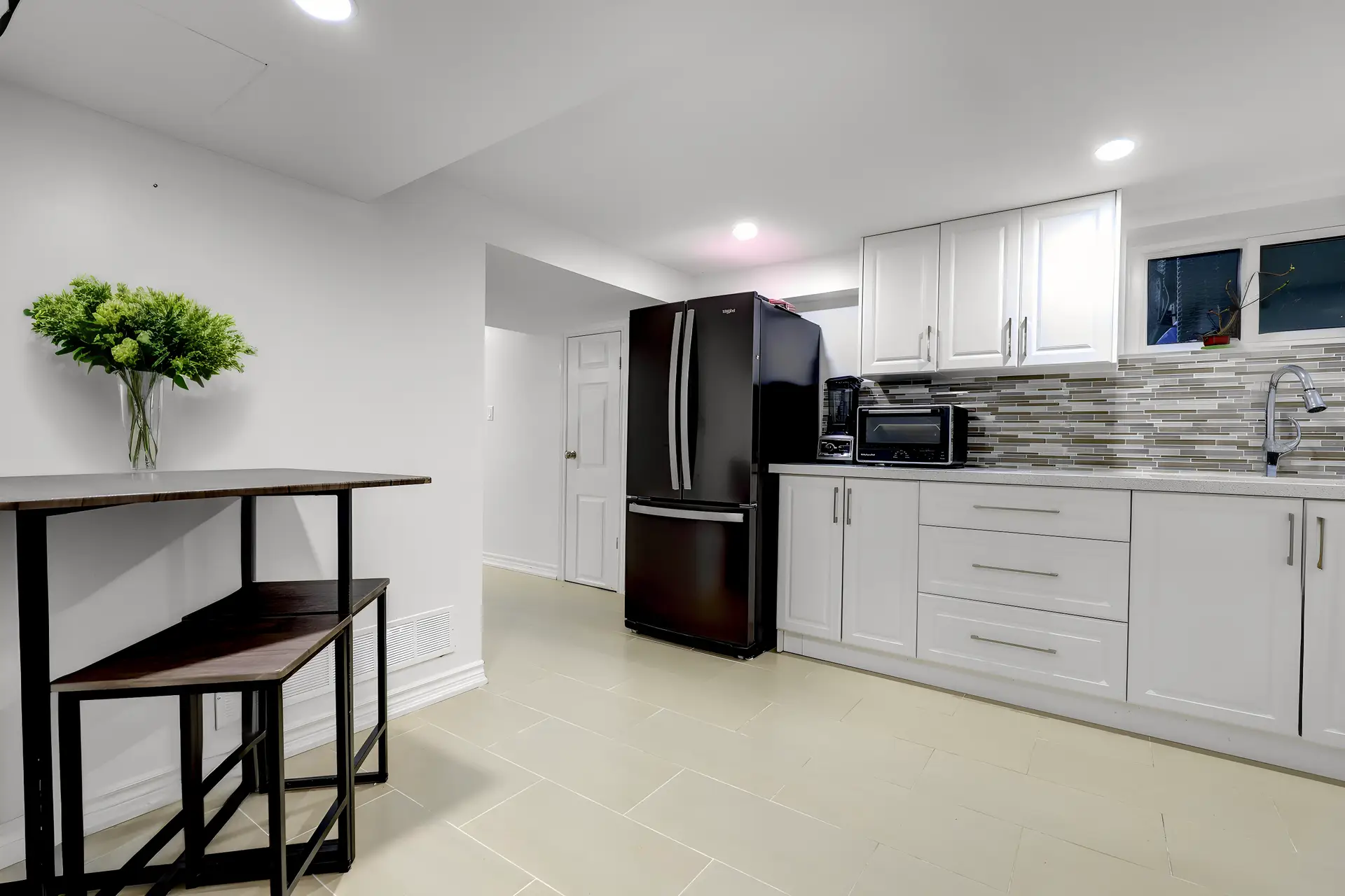 Basement open concept kitchen with added dining area.